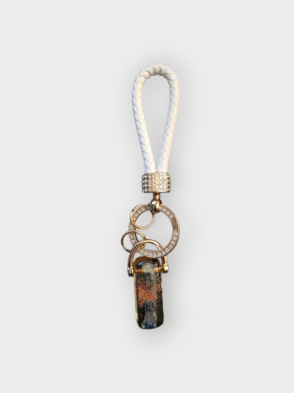 Keychain with decorative elements on a light gray background