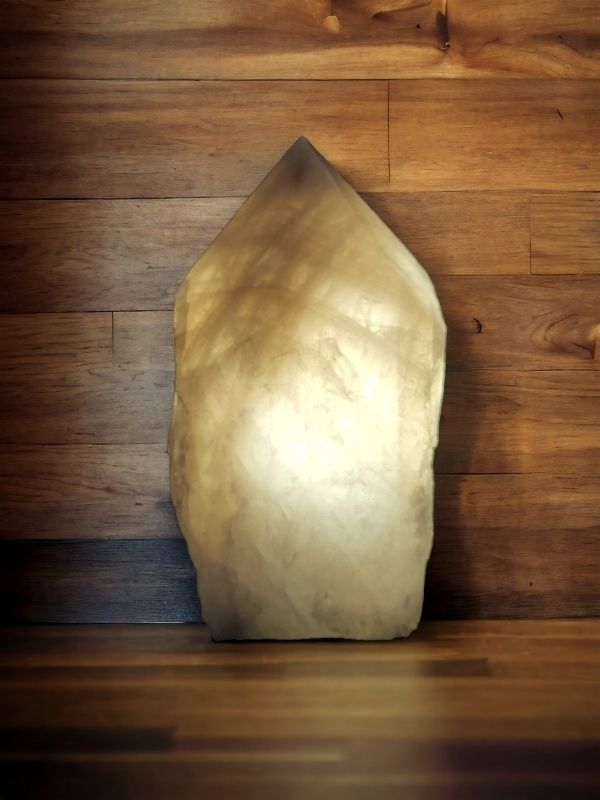 Glowing crystal night-light lamp made from a soft white quartz point