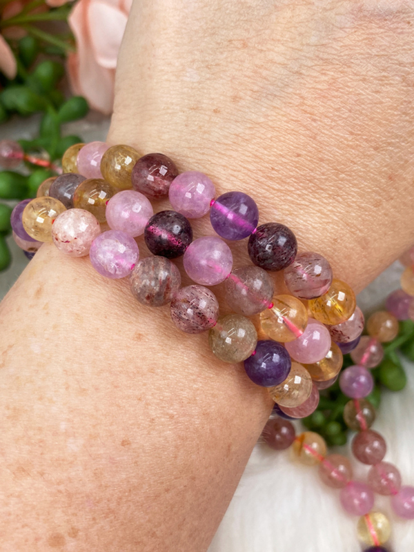 Multicoloured tourmaline crystal bracelet stack on wrist