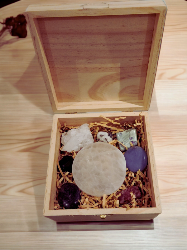Wooden crystal gift box containing amethyst, selenite and assorted stones.