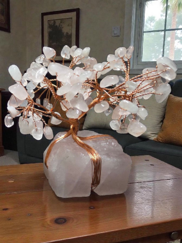 Rose quartz gemstone tree with copper wire branches on a rose quartz base.