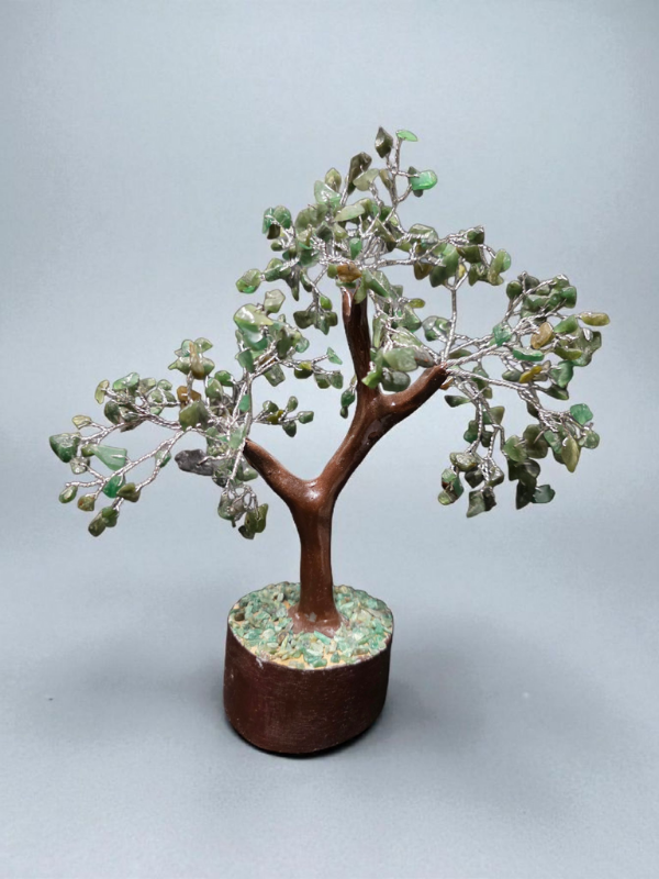 Handcrafted green aventurine crystal tree on a gemstone-filled base.