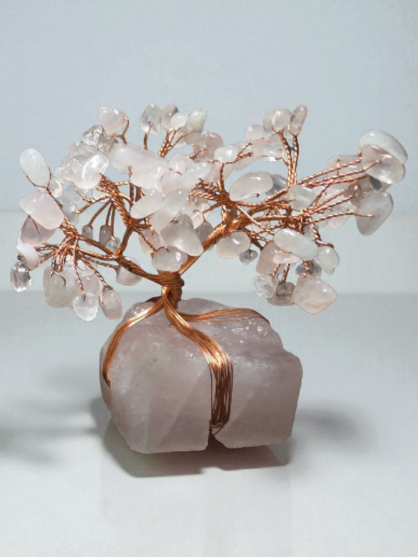 Rose quartz gemstone tree with copper wire branches on a rose quartz base.