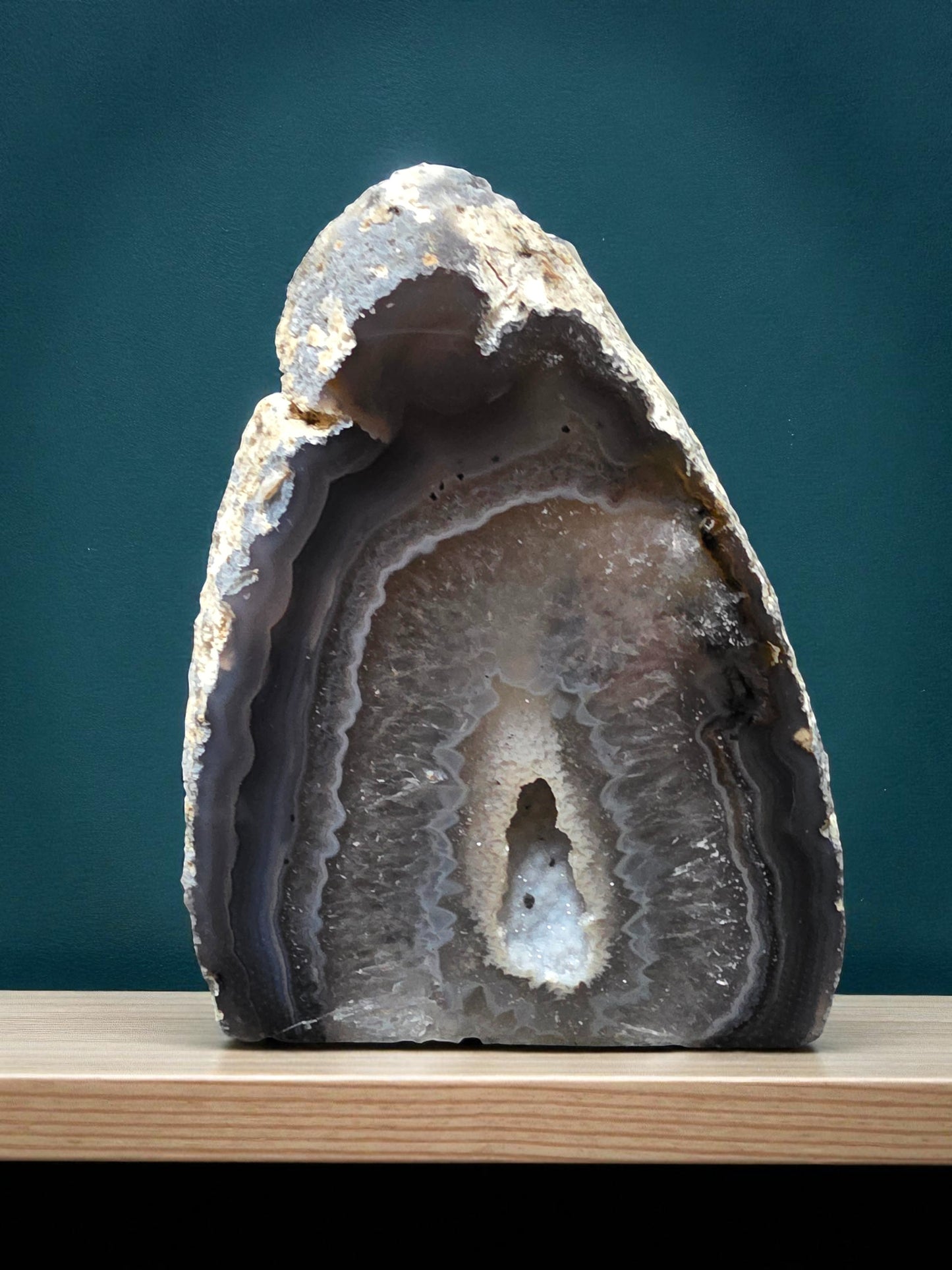 Natural druzy agate standing crystal with visible grey banding and sparkling quartz centre.