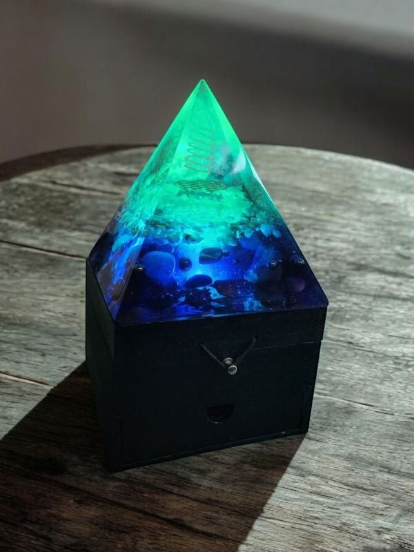Soul Stone Designs Lunar Tides Orgonite Lamp with blue and green resin, crystals, and copper coil on a wooden box.