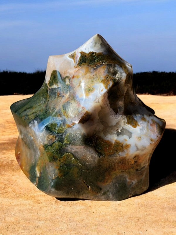 Soul Stone Designs Ocean Jasper Flame, a unique polished stone with green, white, and brown swirls resembling a flame.