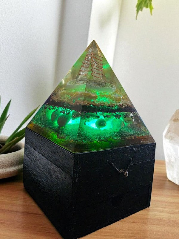 Soul Stone Designs Solar Heart Orgonite Lamp with green glow, clear quartz, selenite, citrine, sunstone, rose quartz, and honey calcite on a wooden box.