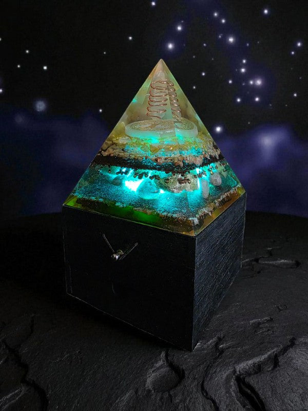Soul Stone Designs Solar Heart orgonite lamp with copper quartz, selenite, citrine, sunstone, rose quartz, and honey calcite. Glows with teal light.