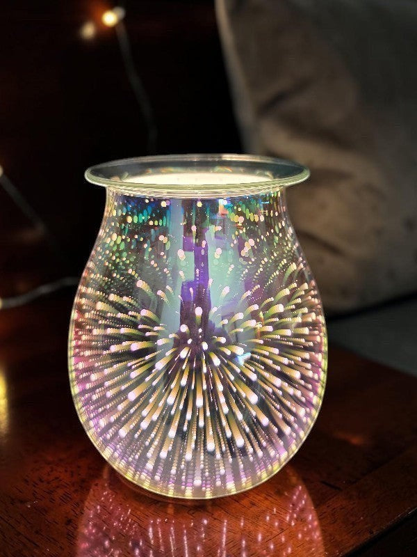 SoulStone Designs 3D fireworks electric wax warmer with iridescent glass creating a glowing light effect on a table.