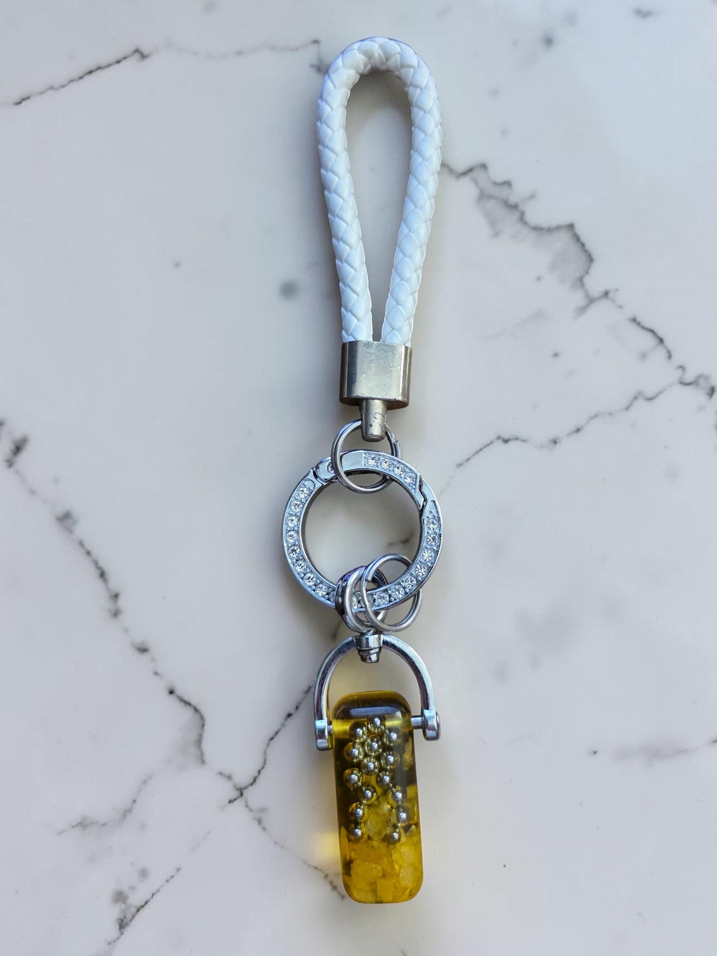 Soul Stone Designs Citrine mini orgonite keychain with white braided strap and silver hardware. Features a clear resin capsule with yellow citrine chips and silver beads.