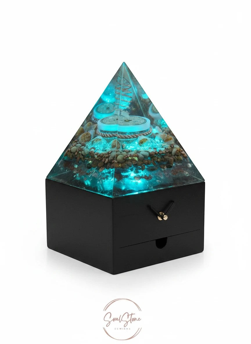 SoulStone Designs pyramid orgonite lamp with blue light, crystals, copper, and wooden base. Supports focus and calm.