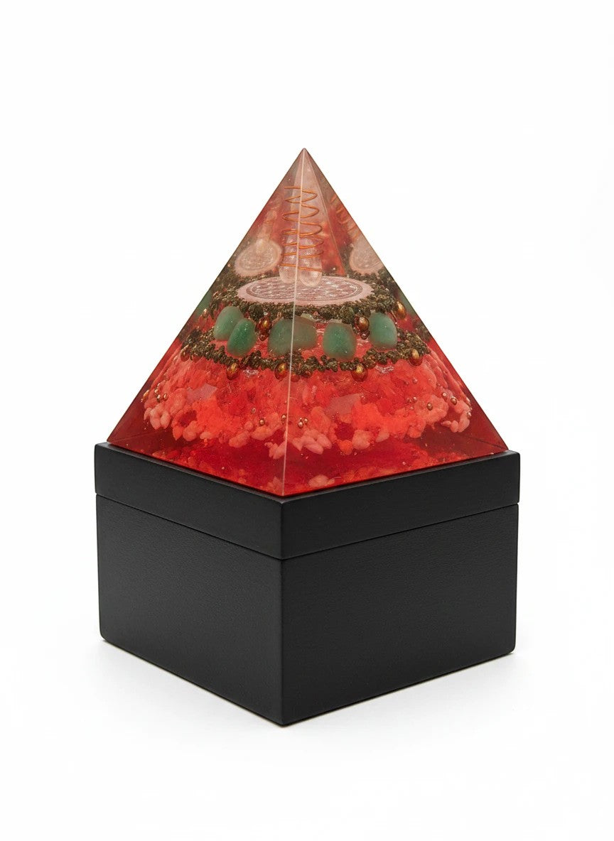Soul Stone Designs Solar Current orgonite pyramid with citrine, pyrite, green aventurine, sunstone, clear quartz, selenite, and copper on a black wooden box.