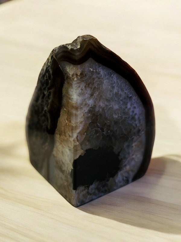Soul Stone Designs natural agate bookend with black, white, and brown banding and a geode center.