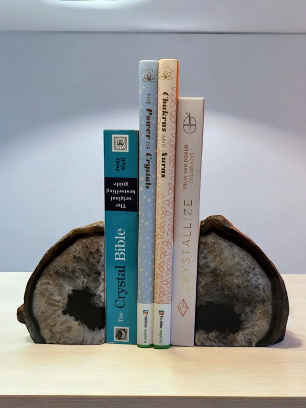 Soul Stone Designs natural agate bookends with grey and white crystal formations holding books on a shelf.