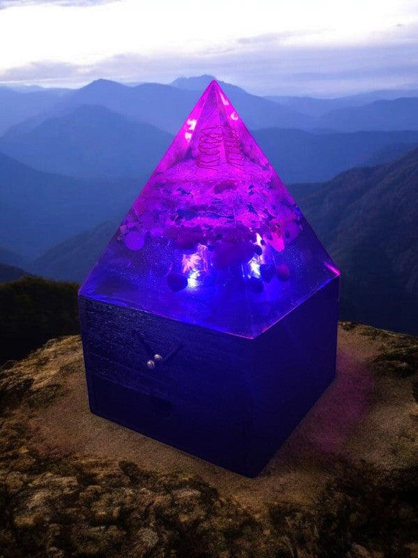 Soul Stone Designs Celestial Drift Orgonite Lamp with purple and blue light, featuring crystals and copper coil, on a wooden box.