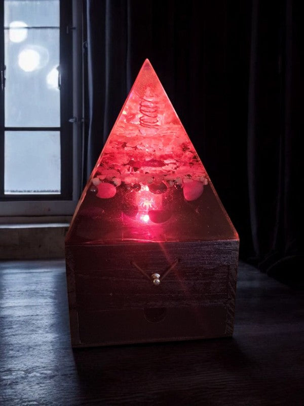 Soul Stone Designs Celestial Drift Orgonite Lamp with red glow, crystals, and copper coil on wooden box.