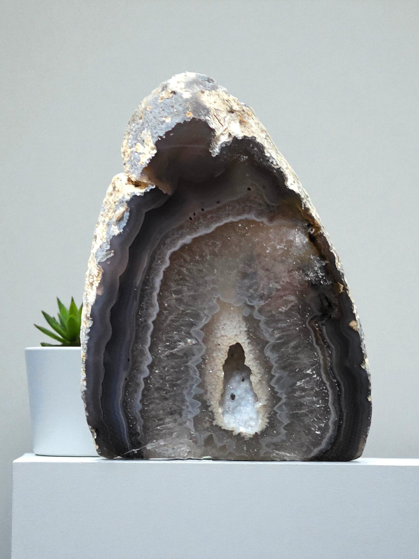 Soul Stone Designs natural druzy agate geode with grey banding and sparkling crystal center, a unique decorative display piece.