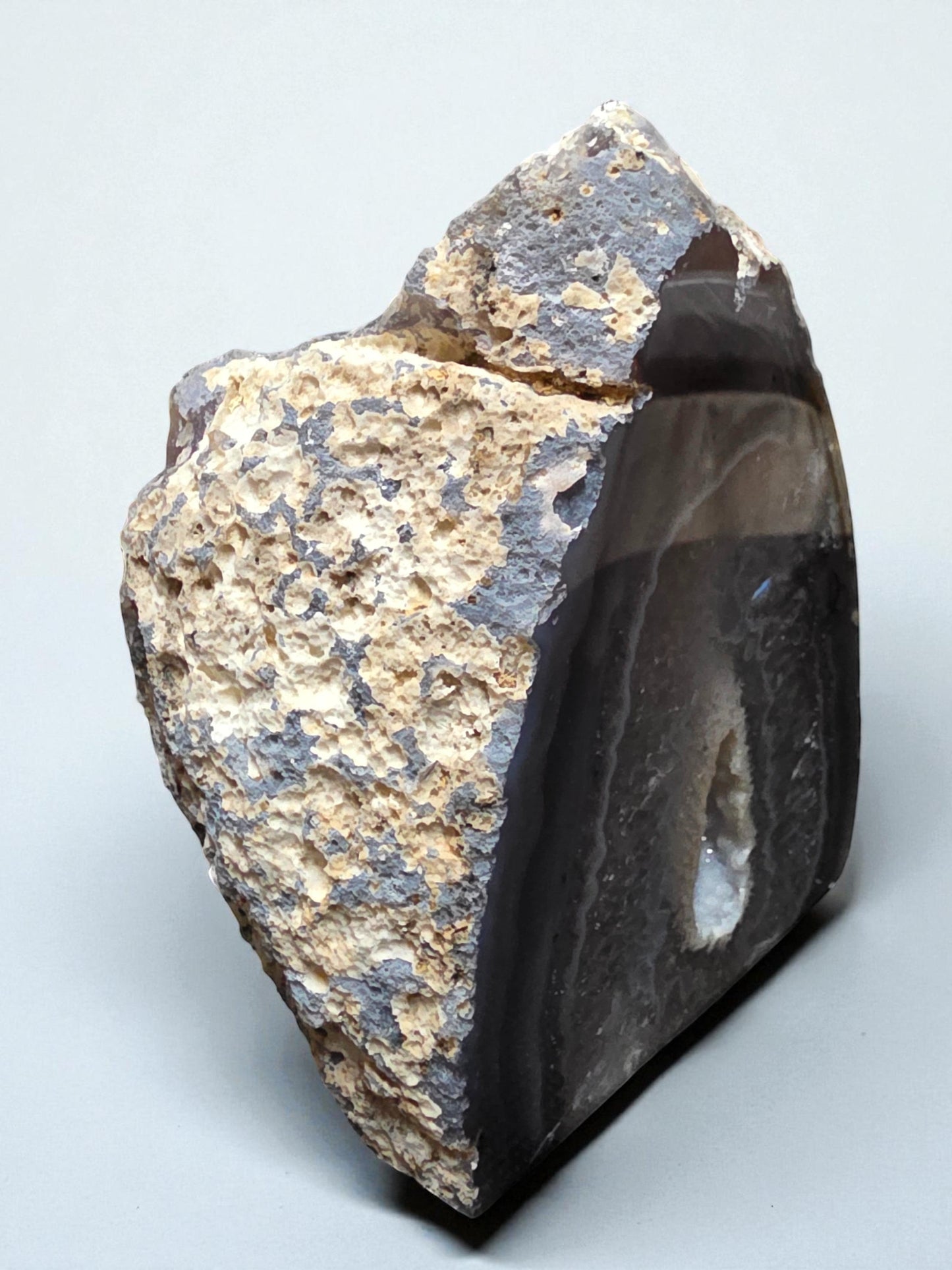 Soul Stone Designs natural druzy agate geode with grey and tan banding and a sparkling crystal-lined cavity.