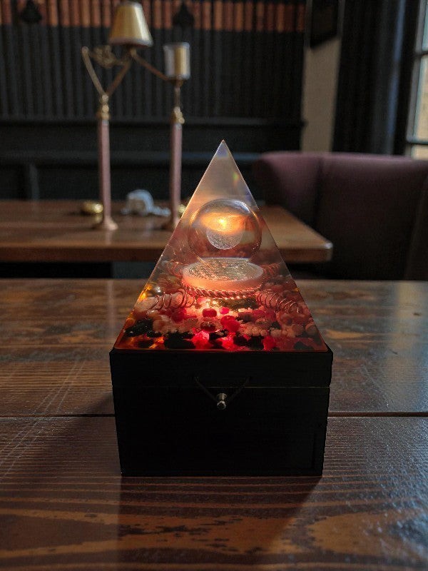 Soul Stone Designs orgonite pyramid lamp with glass sphere, Flower of Life etching, Carnelian, Sunstone, and Black Tourmaline.