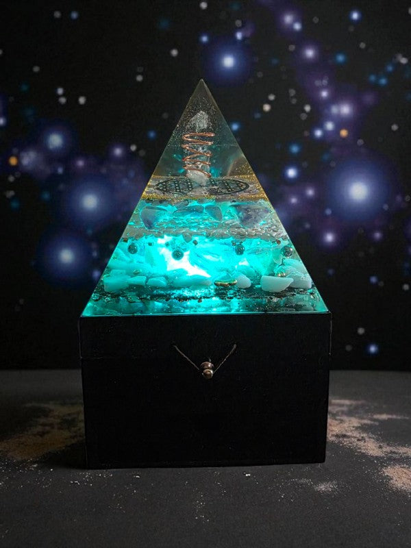 Soul Stone Designs Celestial Clarity Orgonite Lamp with blue and clear crystals, copper coil, and sacred geometry. Glows with teal light.