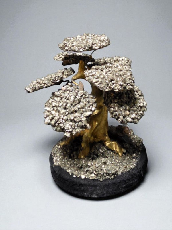 Soul Stone Designs handmade pyrite crystal tree with metallic golden leaves on a dark base, symbolizing abundance and prosperity.