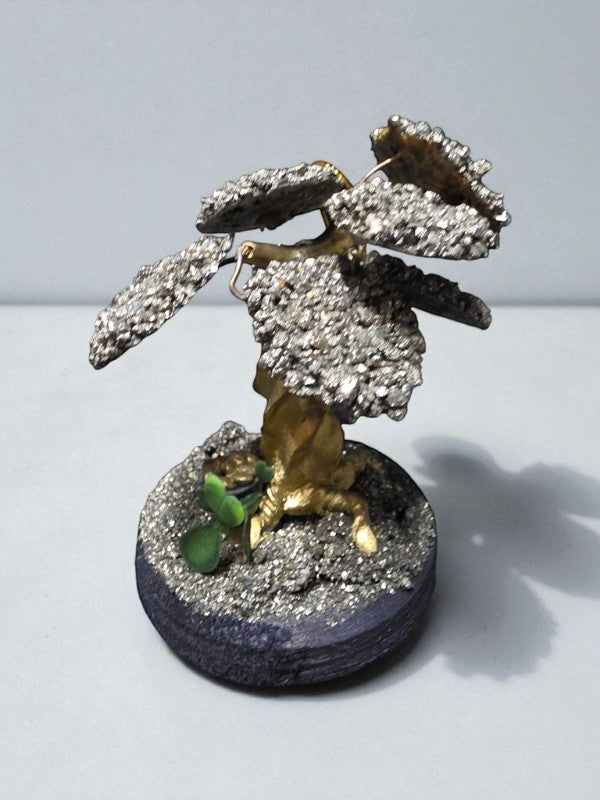 Soul Stone Designs handmade pyrite crystal tree with metallic golden leaves and a small green sprout on a dark base.