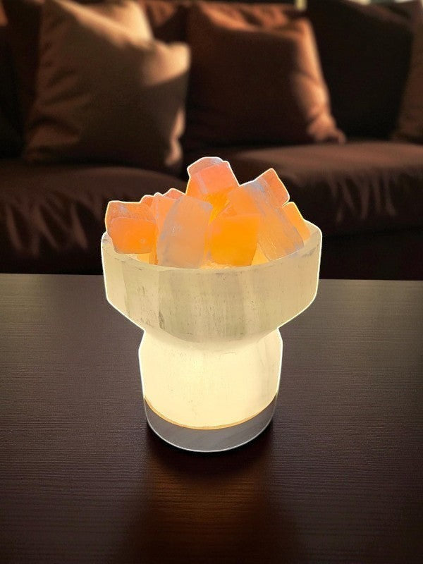 Soul Stone Designs Selenite bowl lamp with peach selenite chunks, emits a warm golden glow.