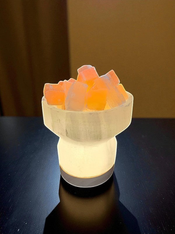 Soul Stone Designs Selenite bowl lamp with peach selenite chunks, emits a warm golden glow, perfect for meditation spaces.