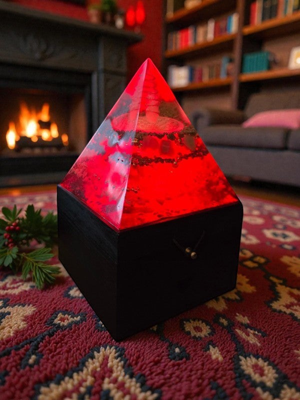 Soul Stone Designs Solar Current orgonite pyramid lamp with red LED light, clear quartz, copper coil, and citrine, pyrite, aventurine, sunstone crystals.