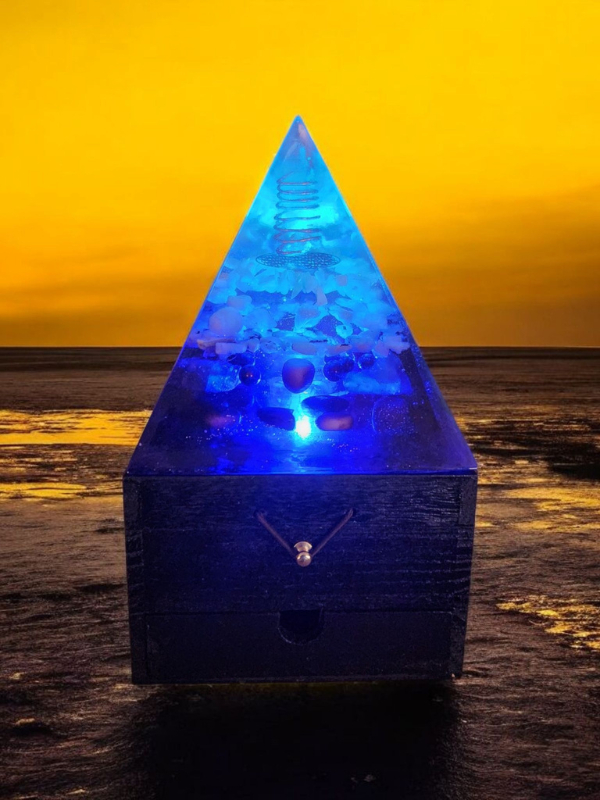 Ocean Serenity is a soothing orgonite lamp featuring a Clear Quartz tower wrapped in copper, harmonized with Selenite, Aquamarine, Rose Quartz, Rainbow Moonstone, and Mookaite